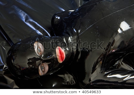 Stockfoto: Portrait Of Lying Woman Wearing Latex Clothes