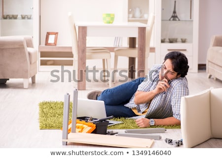 Stock photo: Young Handsome Man Repairing Chair At Home