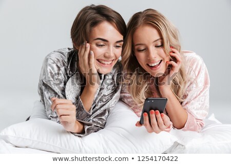 Сток-фото: Two Pretty Girls Wearing Pajamas Isolated Over Gray