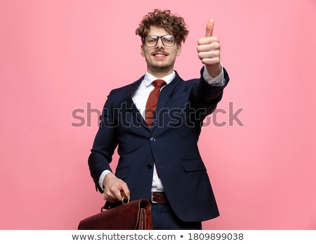 Foto stock: Business Man Holding Briefcase And Making The Victory Sign
