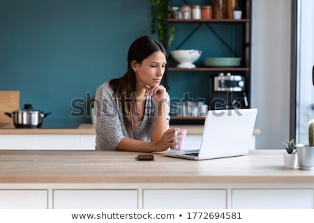 Stok fotoğraf: Close Up Of A Woman Sitting On A Kitchen Table