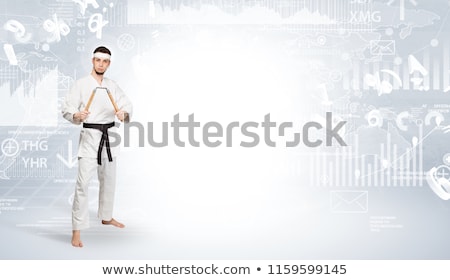 Stock foto: Karate Man Doing Karate Tricks On The Top Of A Metropolitan City