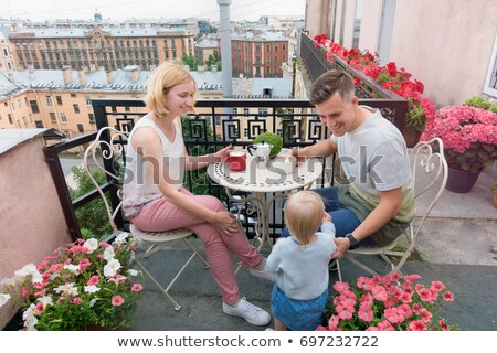 Foto stock: Happy Family Having Breakfast On The Balcony Breakfast Table With Coffee Fruit And Bread Croisant O