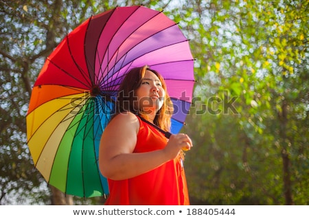 [[stock_photo]]: Happy Fatty Woman With Umbrella