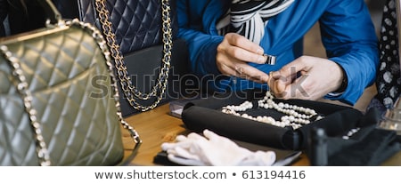 Foto d'archivio: Jeweler Examining Diamond Through Loupe