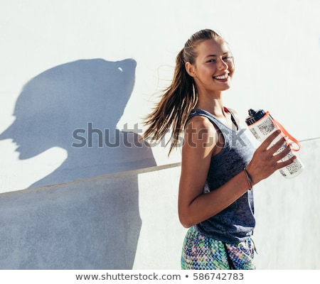 Foto stock: Sports Woman Outdoors Holding Bottle With Water