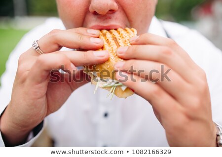 Foto stock: Man In Checked Shirt Eating Tasty Burger Outdoors