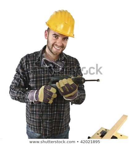Stockfoto: Portrait Of A Smiling Construction Worker In Hardhat Standing Next To Truck On Construction Site