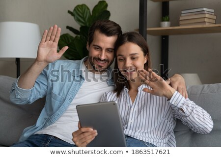 [[stock_photo]]: Screen Of Digital Video Camera With Two Vloggers Sitting On Chairs And Talking