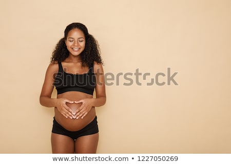 Foto stock: Portrait Of A Young Pregnant Woman In Studio