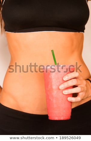 Stock photo: Slender Female Torso Tanned Toned Body Blended Fruit Smoothie Drink
