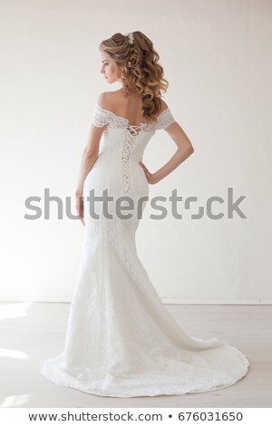 Сток-фото: Elegant Brunette Bride Posing In Traditional Wedding Dress Isolated On White