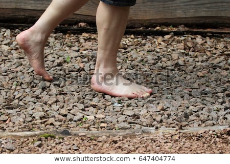Сток-фото: Man Walking On A Textured Cobble Pavement Reflexology Pebble Stones On The Pavement For Foot Refle