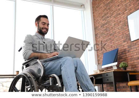 Stock foto: Handicapped Man Using Laptop On Wheelchair
