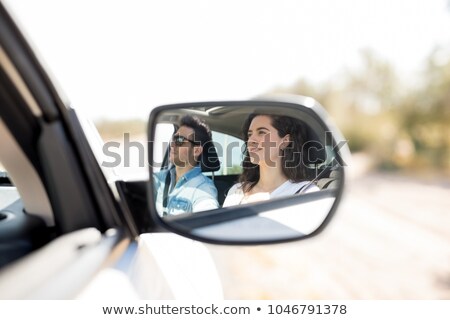 Stok fotoğraf: Reflection Of Woman In Wing Mirror Driving A Car