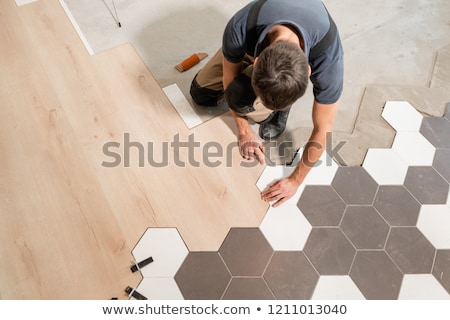 Сток-фото: Professional Contractor Laying Flooring At Home