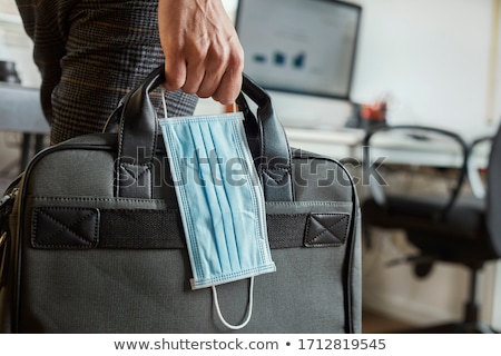 Сток-фото: Man With A Briefcase And A Surgical Mask