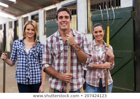 Stockfoto: A Young Girl Standing On A Pitch Fork