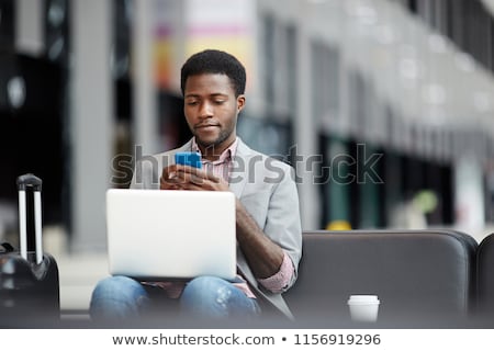 Black Man With Smartphone And Suitcase Stockfoto © Pressmaster