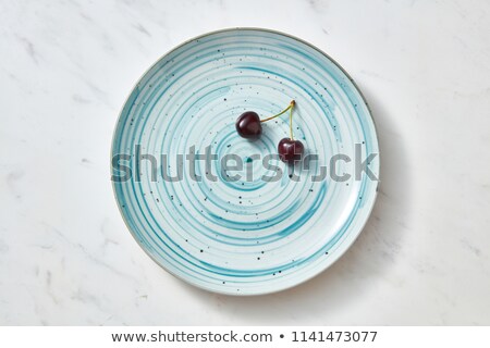 Two Ripe Sweet Dark Red Cherries In A Blue Ceramic Plate On A Gray Stone Background Stockfoto © artjazz