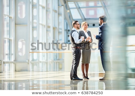 Homme d'affaires souriant dans la salle de verre [[stock_photo]] © Pressmaster