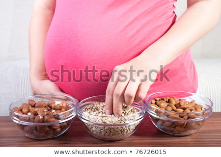 Zdjęcia stock: Happy Pregnant Woman Eating Cereal Flakes At Home