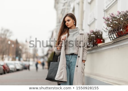 A Beautiful Young Girl In A White Coat Is Standing Near The Shelter And Holding A Red Folder Under H Stok fotoğraf © Alones