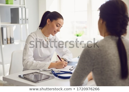 Stockfoto: Doctor Sitting With Girl Patient In Clinic