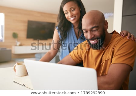 Stok fotoğraf: Couple In Front Of A Laptop