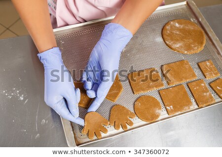 Foto stock: Two Hands In Gloves Holding Pans