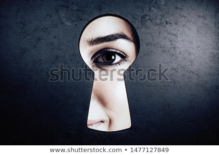 Stok fotoğraf: Eye Looking Through A Keyhole