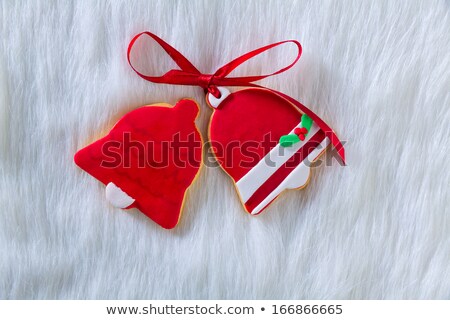 Foto stock: Christmas Cookies Red Bell Shape And Ribbon On White Fur