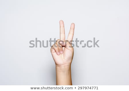Stok fotoğraf: Hand With Two Fingers Up In The Peace Or Victory Symbol