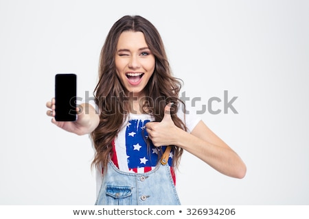 Foto stock: Woman Showing Blank Smartphone Screen And Thumb Up