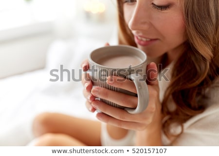 ストックフォト: Close Up Of Woman With Cocoa Cup In Bed At Home