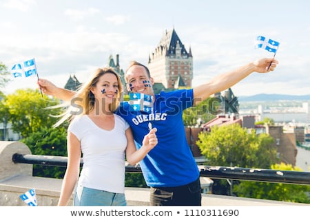 Stockfoto: Couple Celebrates The National Holiday In Front Of Chateau Frontenac In Quebec City