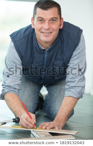 Stock photo: A Kneeled Tiler