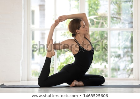 Foto d'archivio: Women Practising Yoga In Studio