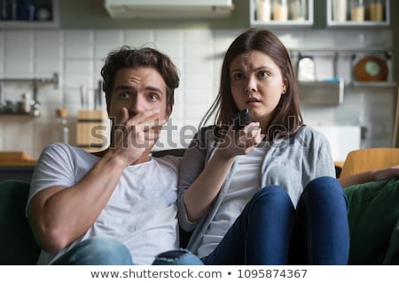 Stock photo: Scared Couple Watching Television