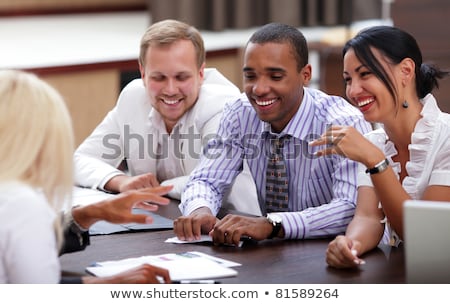 Сток-фото: Happy Business People Sitting Around The Table At The Meeting