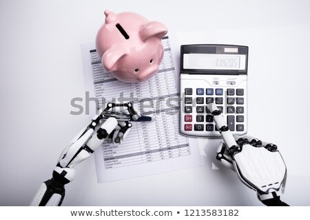 Stock photo: Robot Examining Financial Report With Calculator