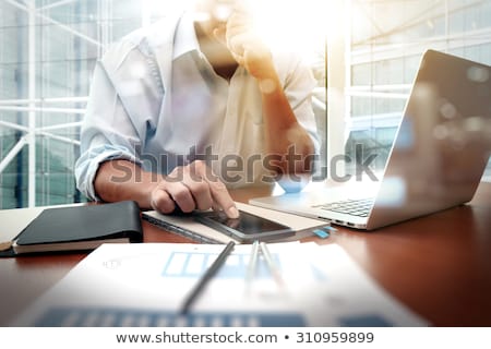 Stock foto: Business Man Working At Office With Laptop Tablet And Graph Dat