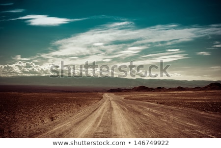 Stock fotó: Empty Rural Road Going Through Prairie Under Cloudy Sky