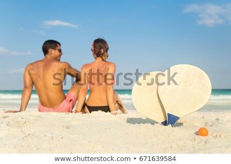 [[stock_photo]]: Portrait Of Two Girls Playing Rackets On The Beach