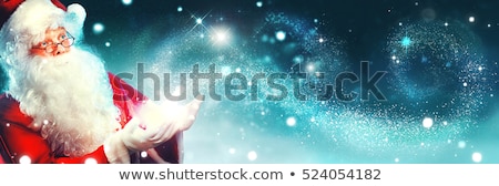 Foto stock: Santa Claus At Night Making Magic