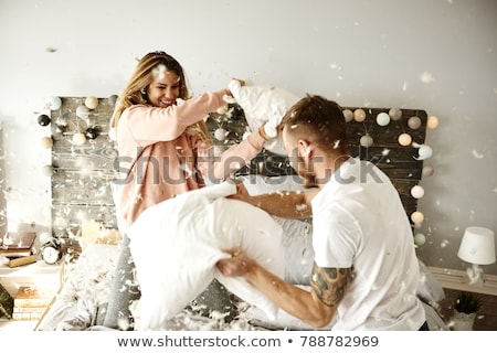 Stock photo: Portrait Of Girlfriends Fighting With Pillows At Home
