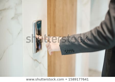 ストックフォト: Human Hand Holding Elevator Key