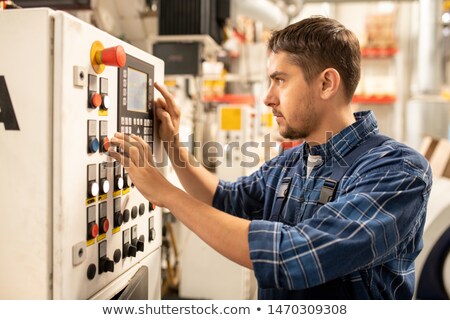 Young Worker Choosing Parameters Of Raw Thermoplastic Material Processing Stockfoto © Pressmaster