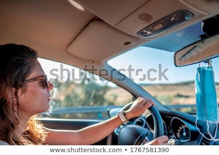 ストックフォト: Rear View Of Young Mixed Race Woman With Sunglasses Sitting At Poolside In Backyard Of Home On A Sun