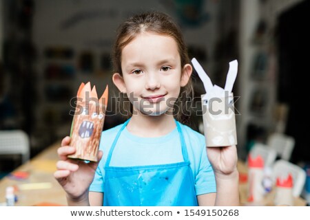 Stock photo: Pretty Schoolgirl Showing Scary Halloween Handmade Toys Made Up Of Rolled Paper